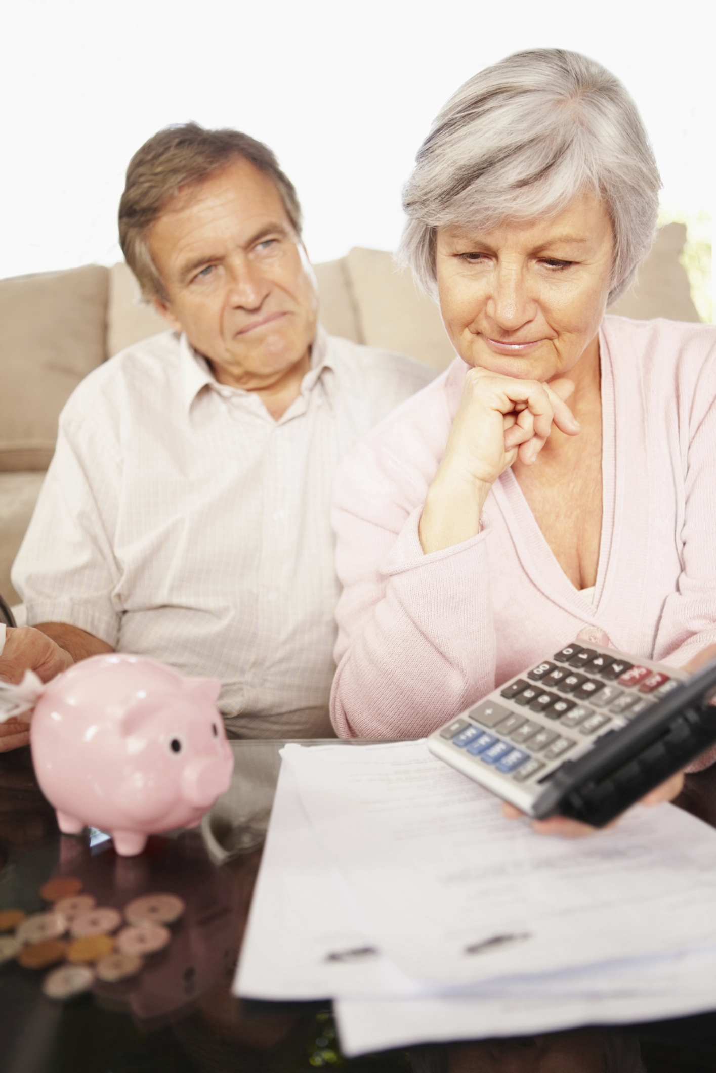 Elderly couple calculating their monthly expenses at home